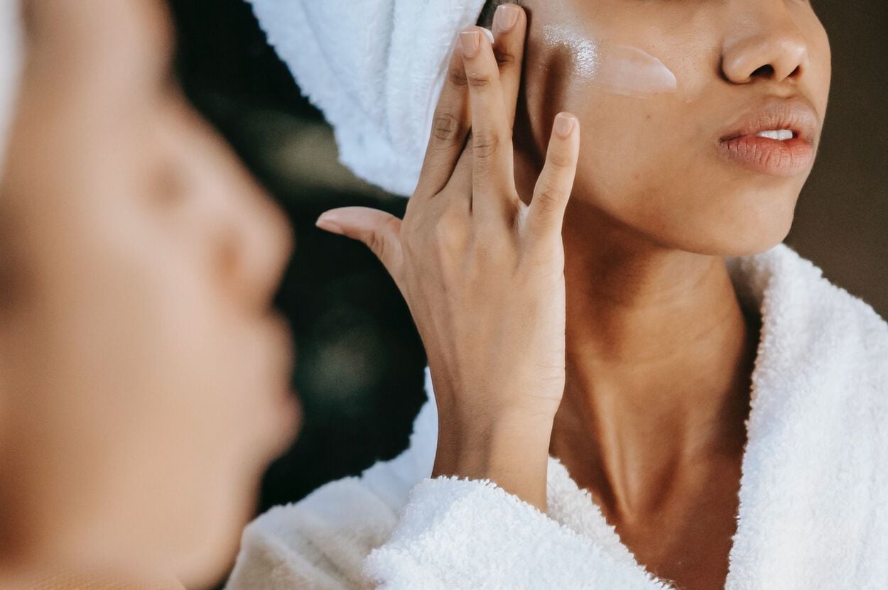 vrouw smeert niacinamide op gezicht