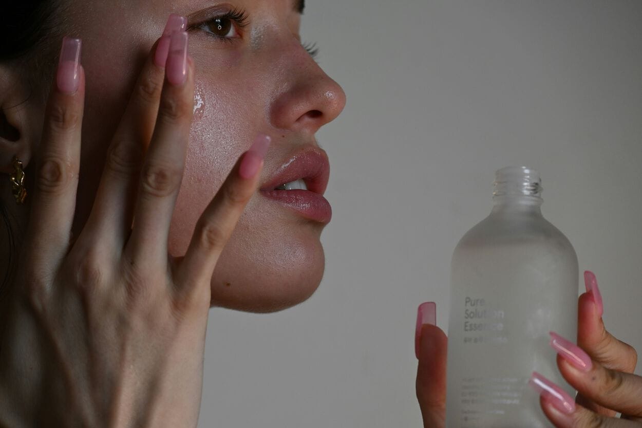 Vrouw die huid insmeert met creme voor Dermatitis