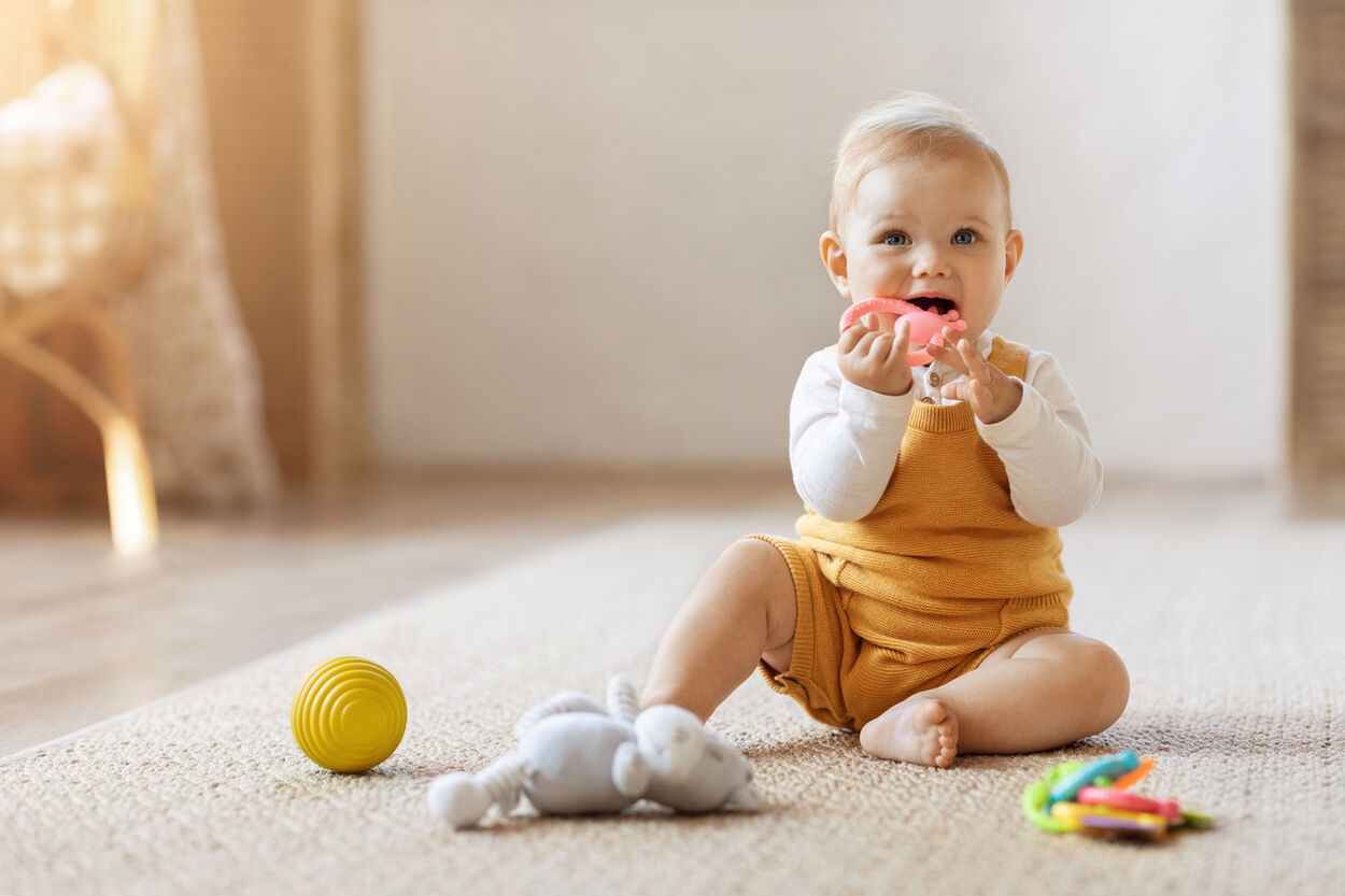 Baby die aan het spelen is. Ze zit midden in de sprongfase.